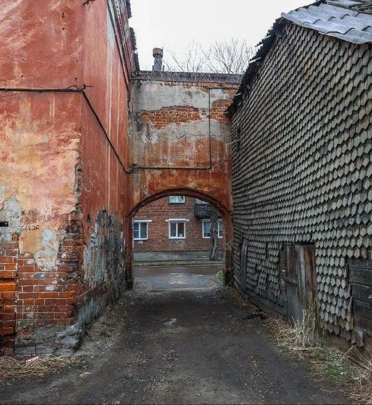 Двухэтажный дом с аркой на Ударника, 10 признан аварийным и лишён охранного статуса. Жильё на этом небольшом участке не появится — там предполагают обустроить объект благоустройства.