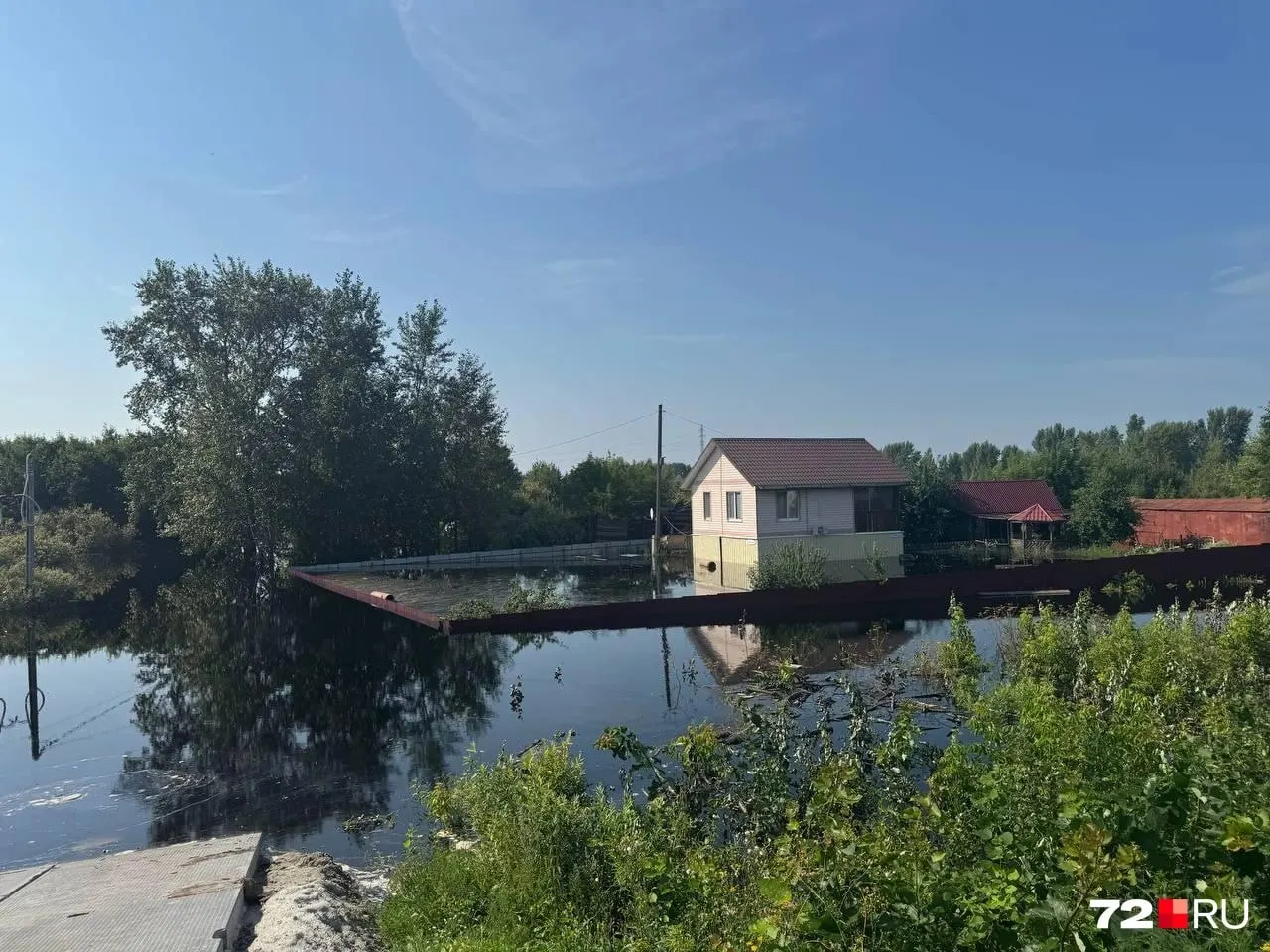 На улице Томская подтоплены приусадебные участки и подъезды к домам: вода подошла вплотную к оградам, люди набивают мешки с песком и перекрывают проезд.